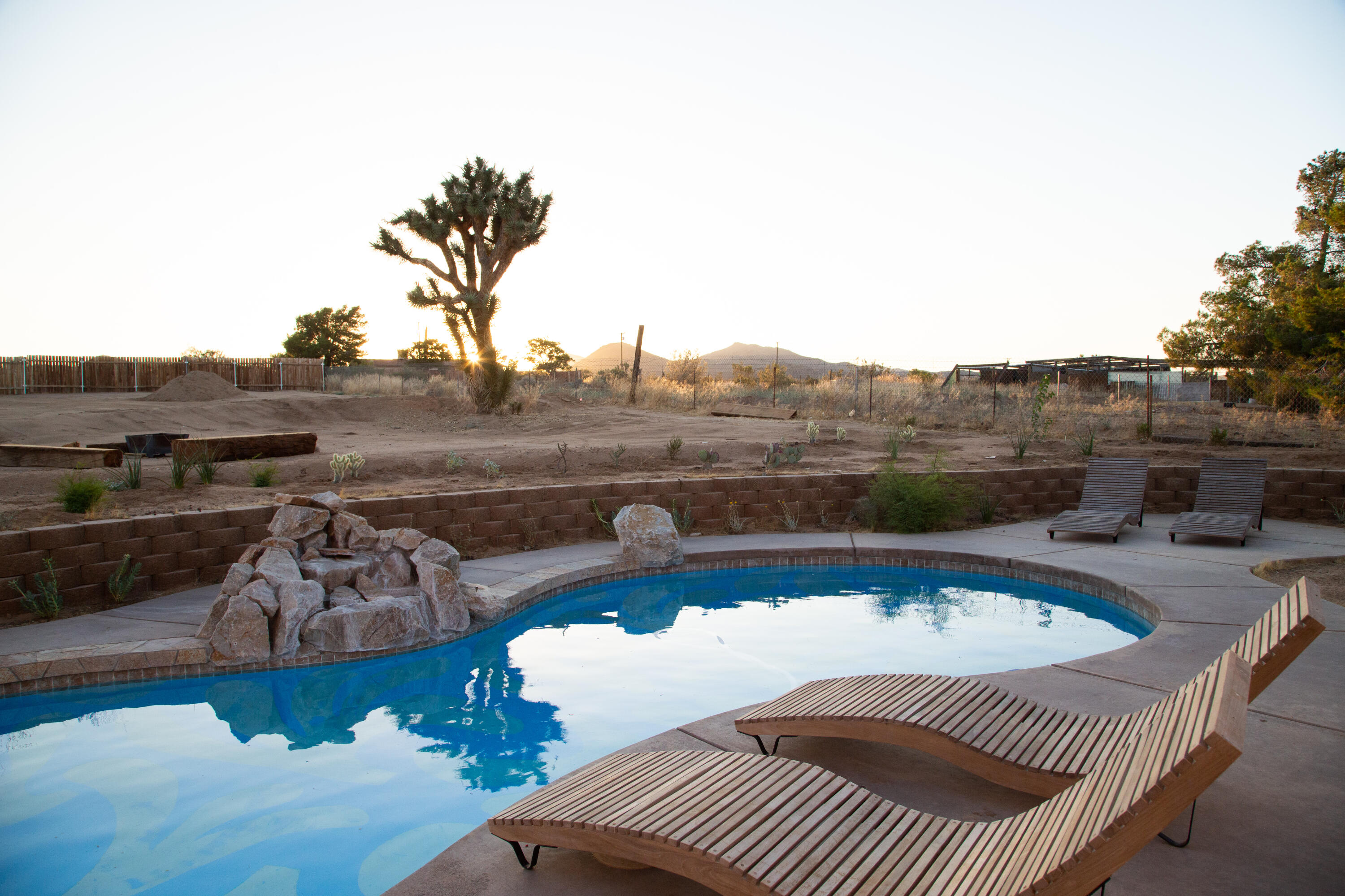382 Cherokee Trail Yucca Valley, CA 92284 - Photo 57 of 66 a view of a roof deck with couches and wooden floor