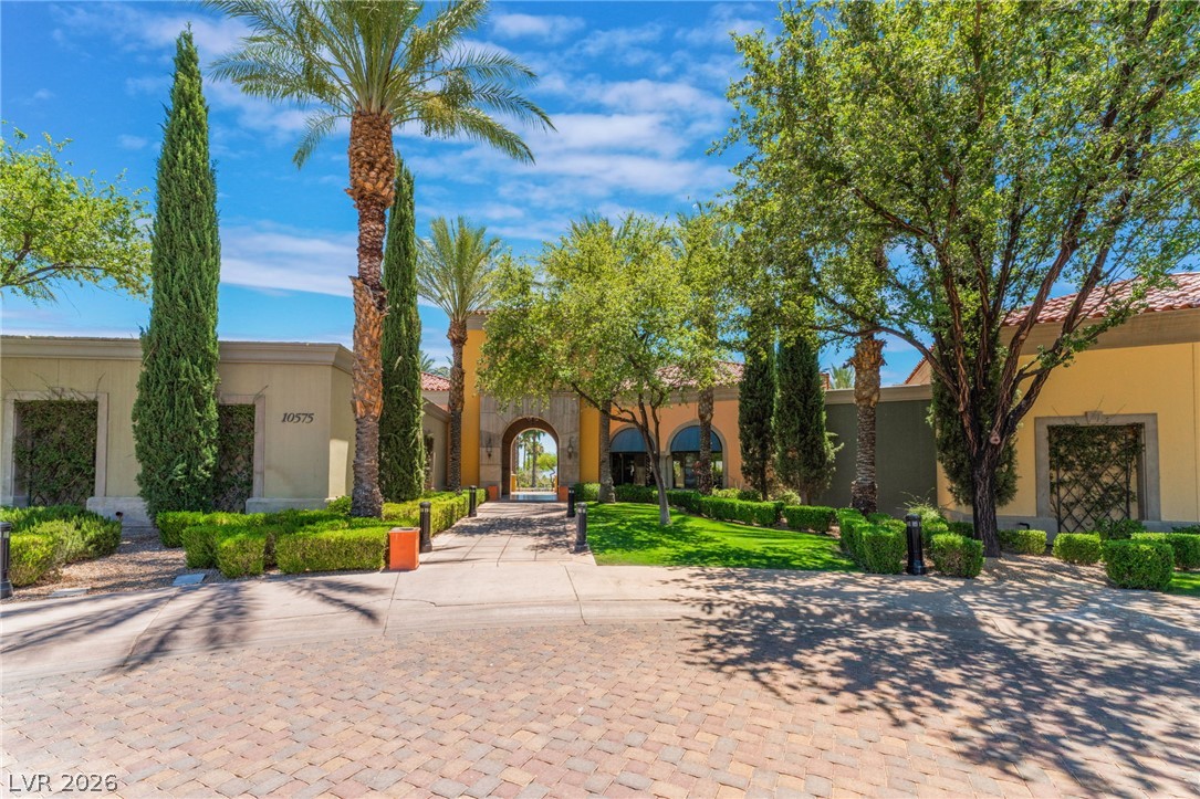 5389 Progresso Street Las Vegas, NV 89135 - Photo 39 of 41 Enter through a grand archway into this exquisitely landscaped property with lush greenery and mature palm trees.