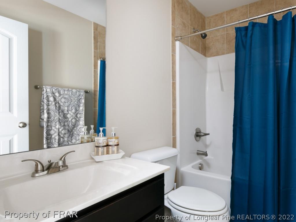534 Townsend Road Raeford, NC 28376 - Photo 18 of 35 a bathroom with a sink toilet a mirror and shower