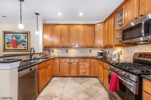 a kitchen with stainless steel appliances granite countertop a stove sink and cabinets