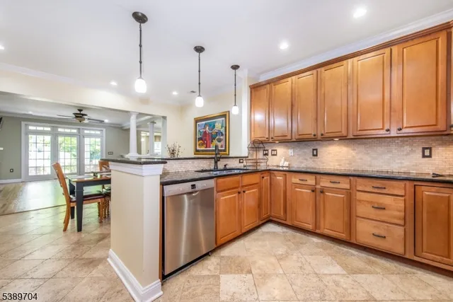 a kitchen with granite countertop cabinets stainless steel appliances a sink and a window