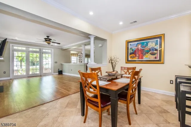 a view of a dining room with furniture wooden floor and a chandelier