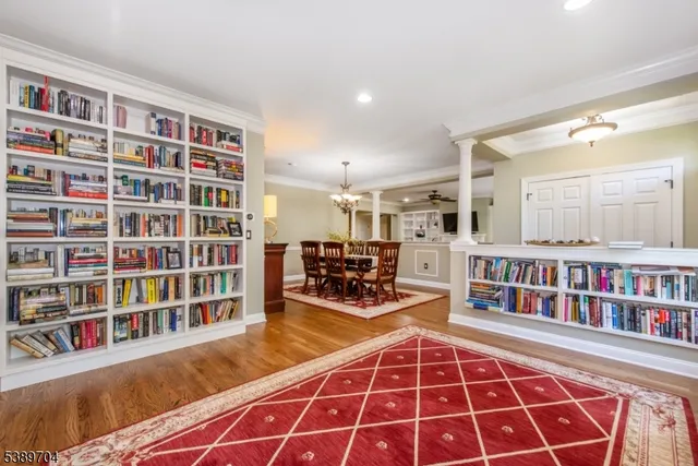 a living room with furniture and a book shelf