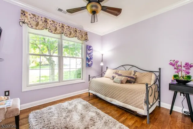 a bedroom with a bed chandelier and a window