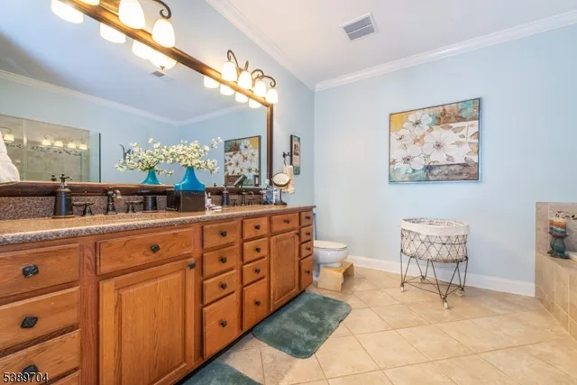 a spacious bathroom with a double vanity sink and a mirror