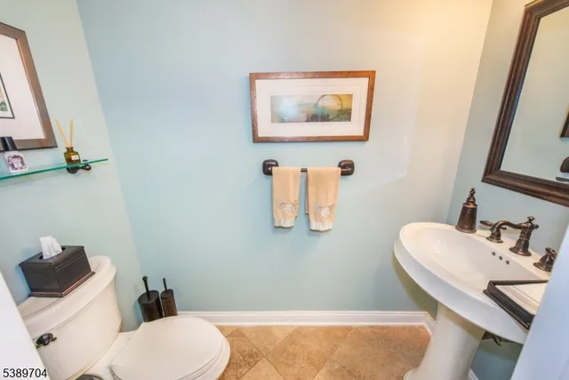 a bathroom with a sink mirror vanity and toilet