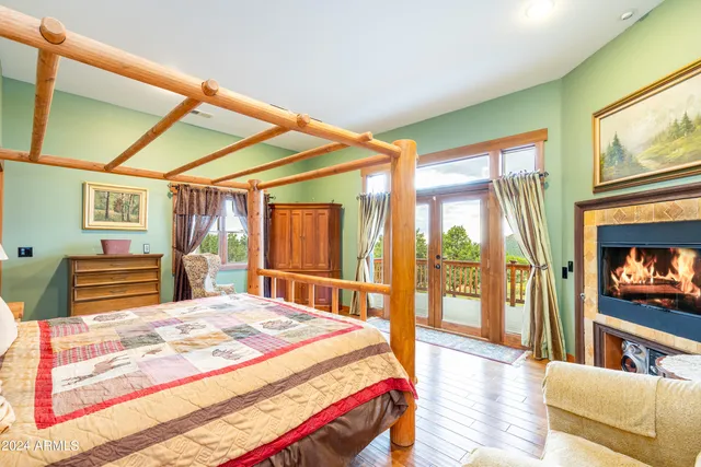 a spacious bedroom with a bed and flat screen tv