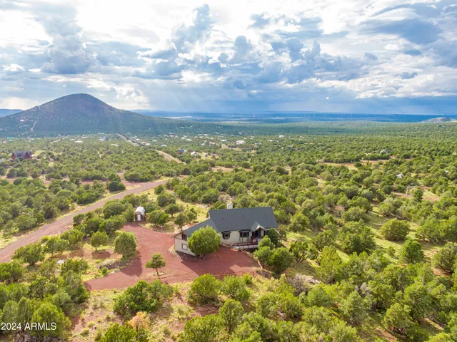 a view of a roof deck with table and chairs with wooden floor and fence