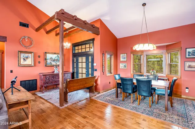 a dining room with furniture and wooden floor