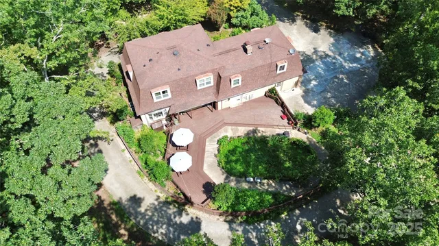 an aerial view of a house with a yard and garden