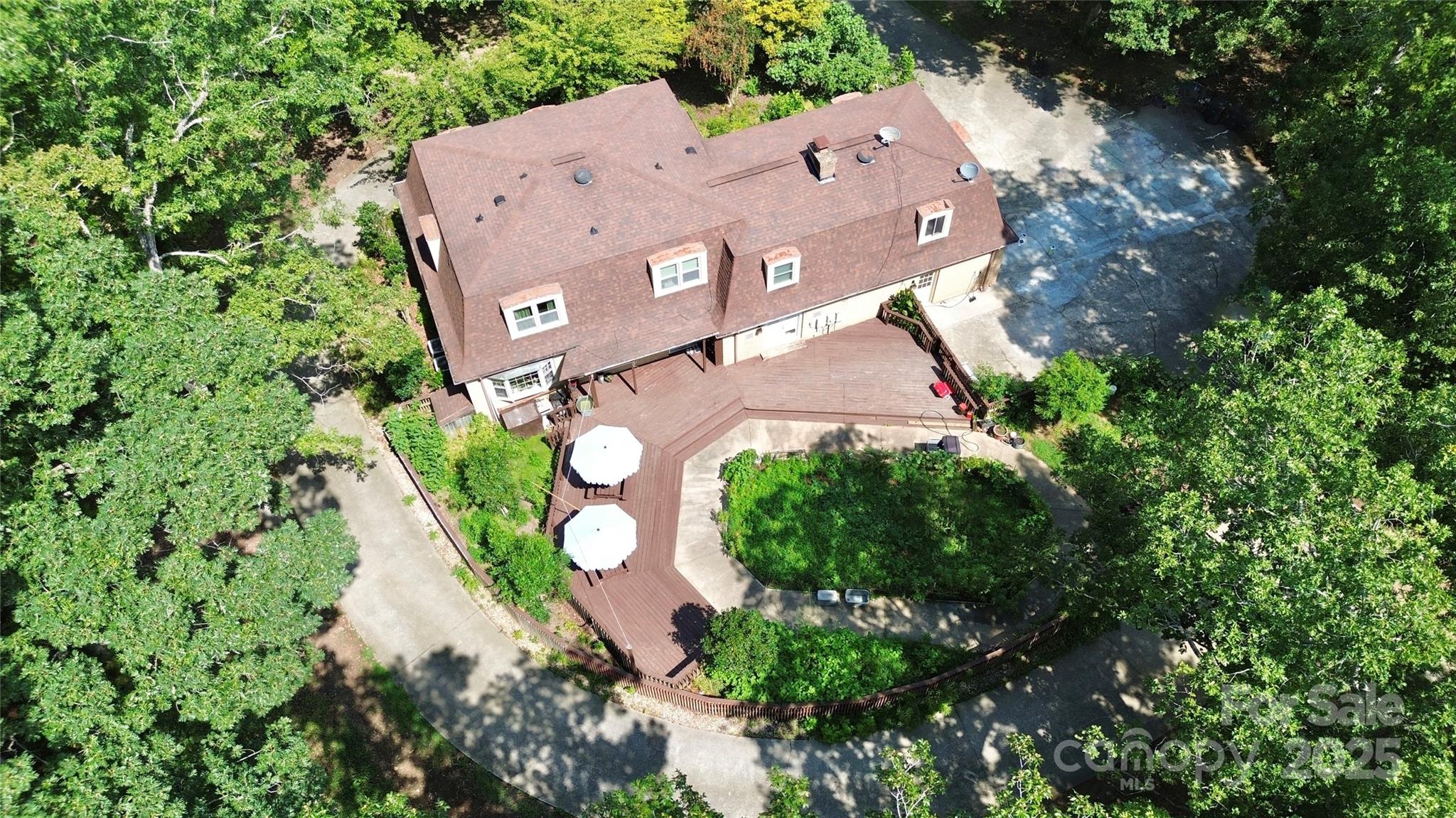 an aerial view of a house with a yard and garden