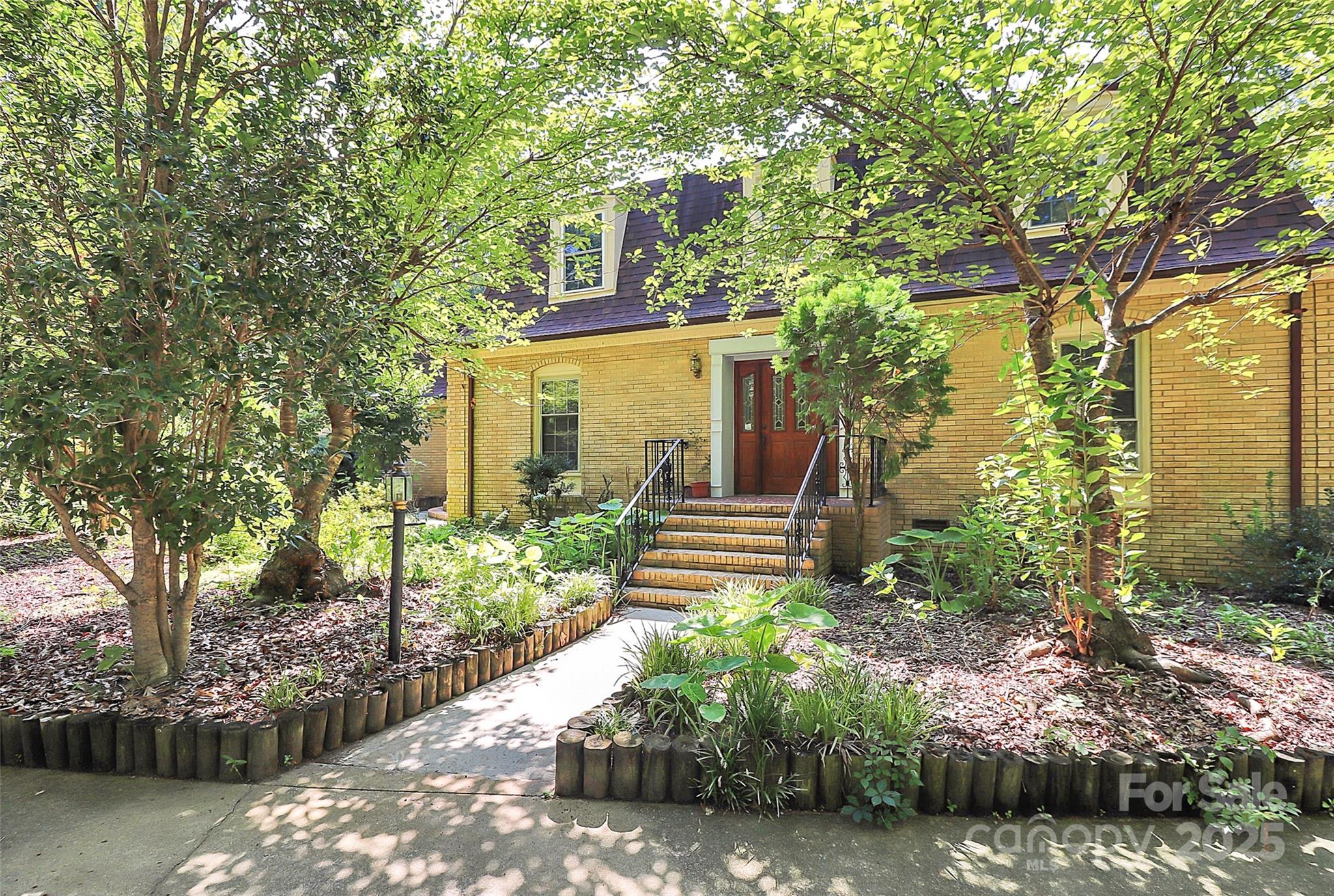 1940 Rock Hill Church Road Indian Trail, NC 28079 - Photo 11 of 46 a front view of a house with garden