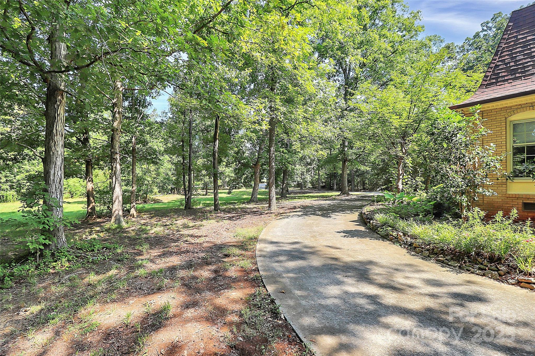 1940 Rock Hill Church Road Indian Trail, NC 28079 - Photo 12 of 46 a view of a yard with plants and trees