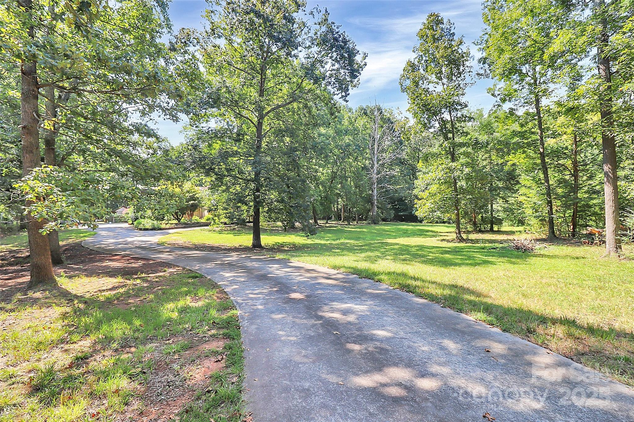 1940 Rock Hill Church Road Indian Trail, NC 28079 - Photo 20 of 46 a view of a swimming pool with a big yard and large trees