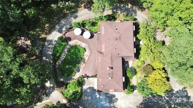 an aerial view of a house with a yard and garden