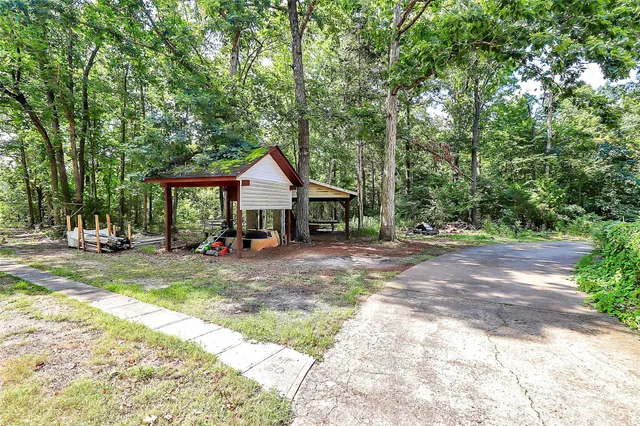a view of a house with yard and sitting area