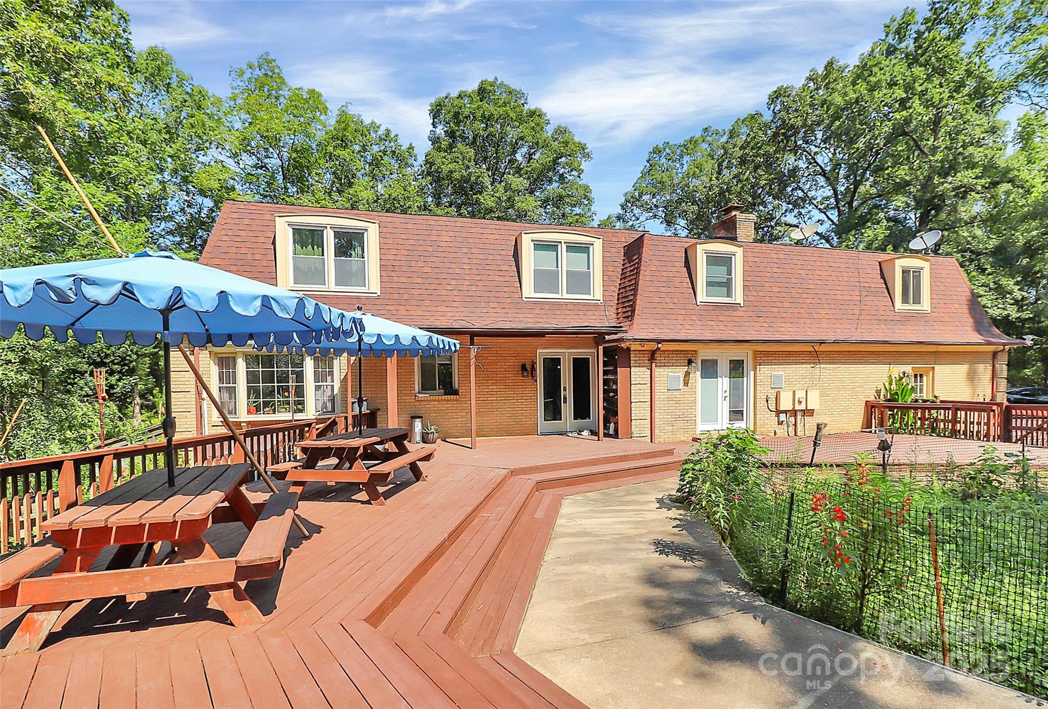 1940 Rock Hill Church Road Indian Trail, NC 28079 - Photo 23 of 46 a view of a patio with couches table and chairs and potted plants