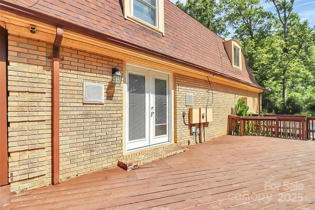 a view of a house with a wooden deck
