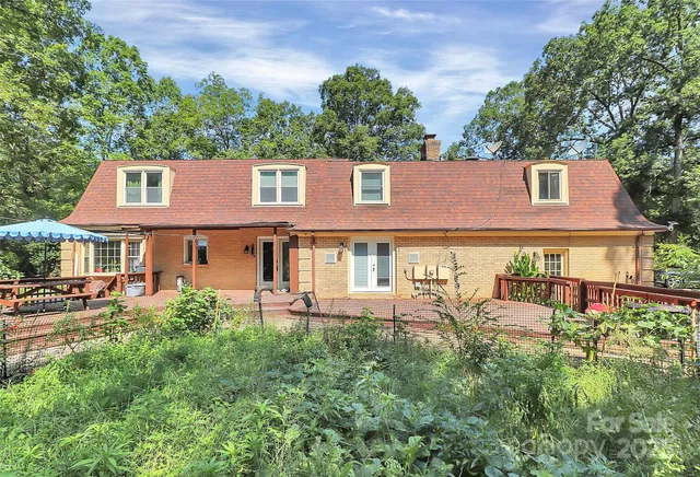 an aerial view of a house with garden space and a street view