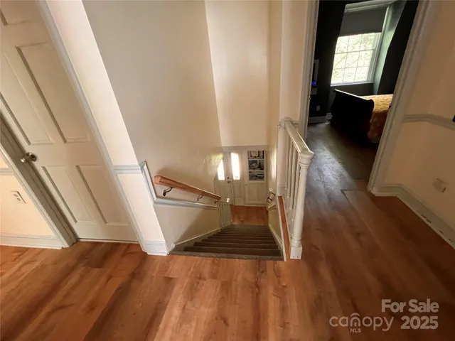 a view of entryway and hall with wooden floor