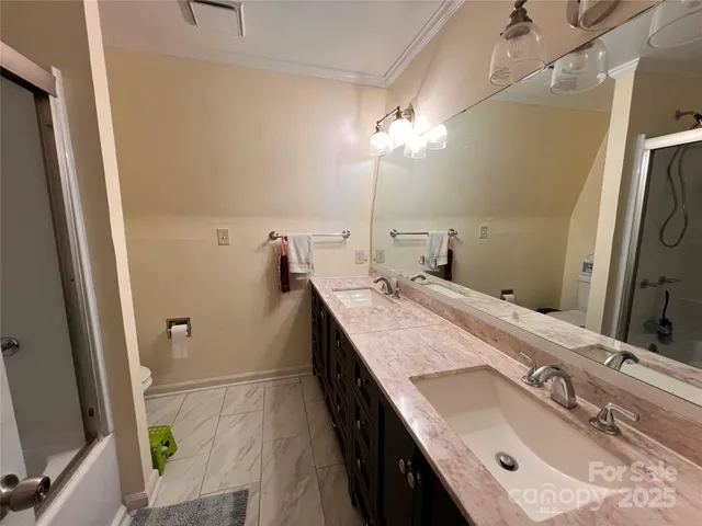 a bathroom with a double vanity sink and a mirror