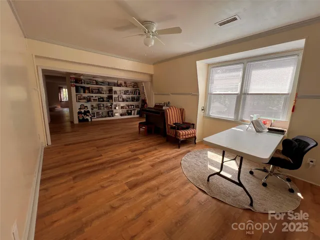 a living room with furniture a flat screen tv and a window