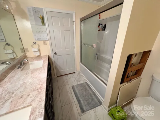 a bathroom with a tub and shower