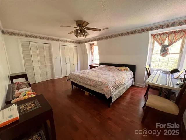 a bedroom with a bed window and a couch