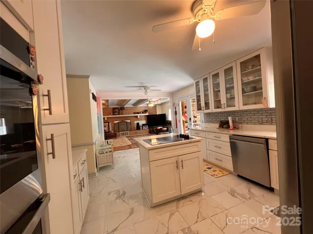 a kitchen with white cabinets and appliances