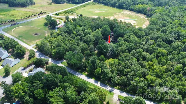 an aerial view of residential house with outdoor space and swimming pool
