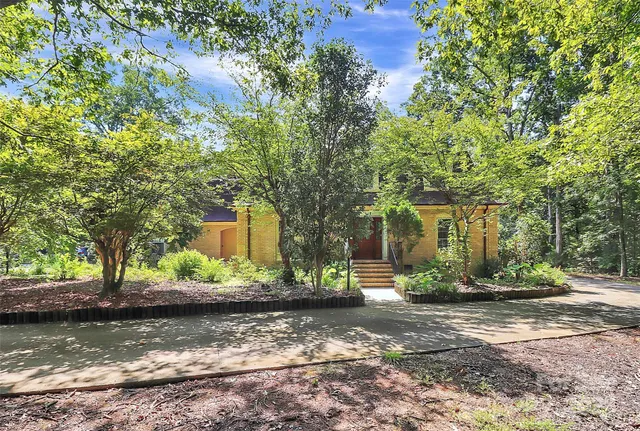 a view of a house with a tree in front