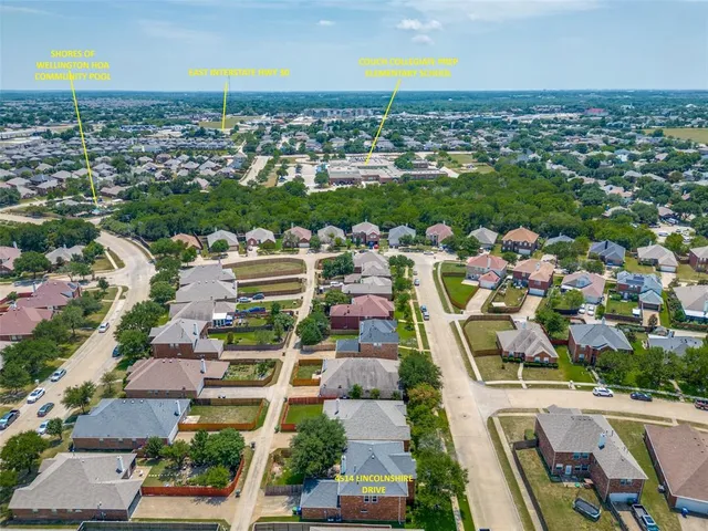 an aerial view of residential houses with outdoor space and swimming pool