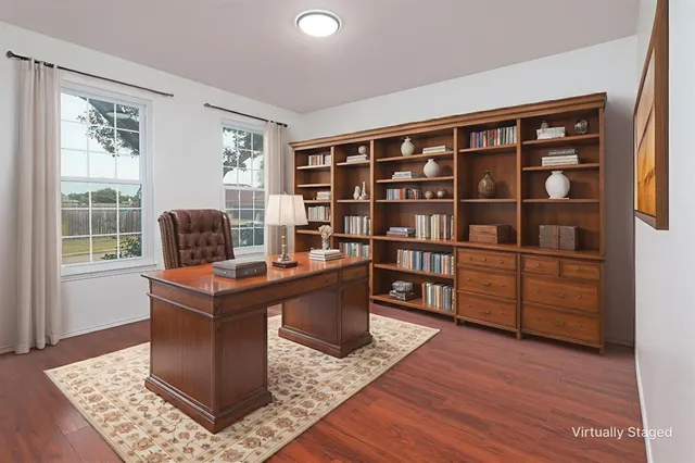 a living room with furniture and a bookshelf