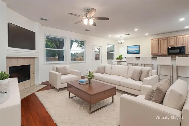 a living room with furniture fireplace and a flat screen tv