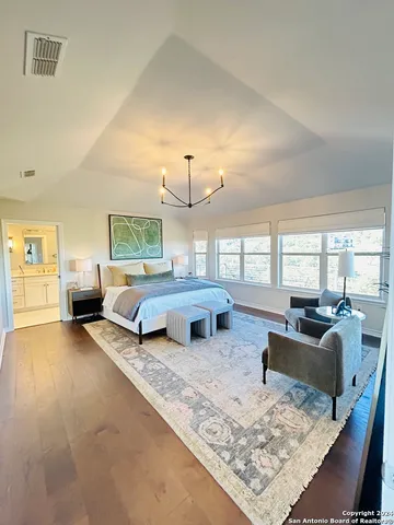 a bedroom with furniture and a large window