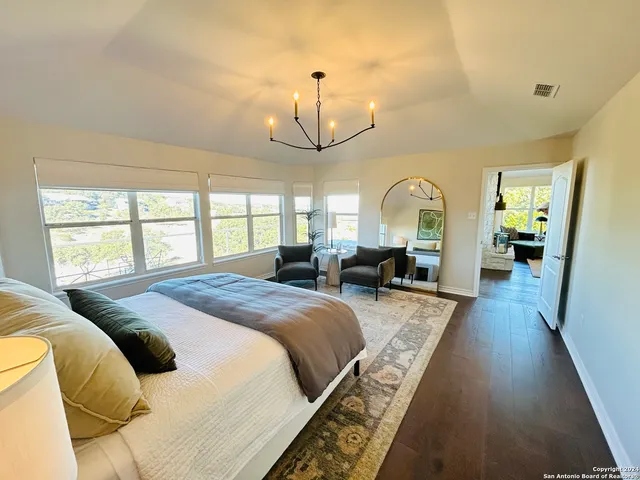 a bed room with a bed mirror and a window
