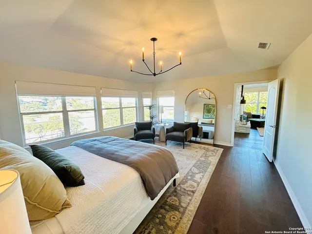 a spacious bedroom with bed and a window