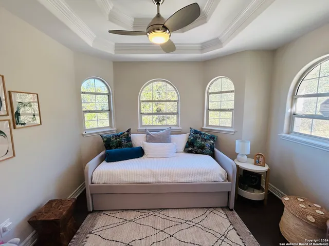 a bedroom with a bed mirror and window