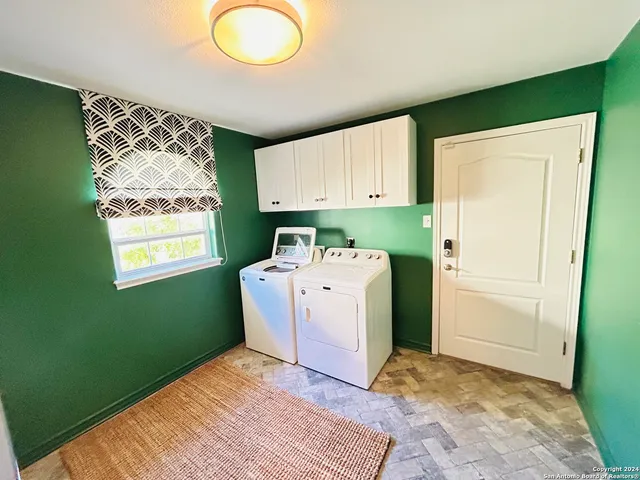 a utility room with washing machine and drawer