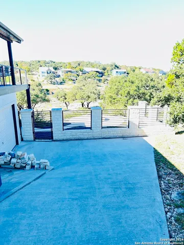 a view of a terrace with hardwood floor and kitchen view
