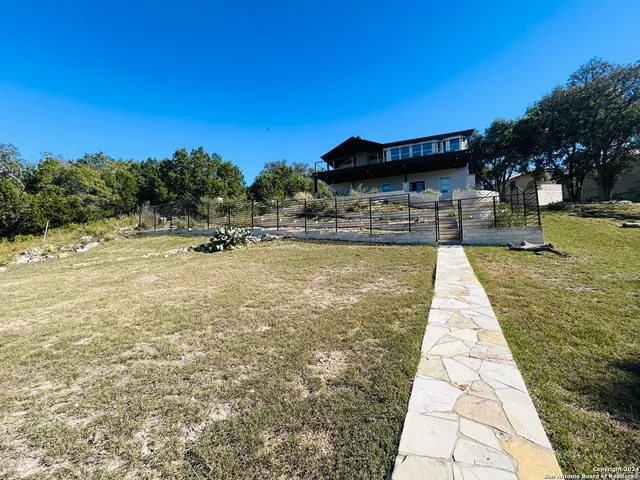 a swimming pool with outdoor seating and yard