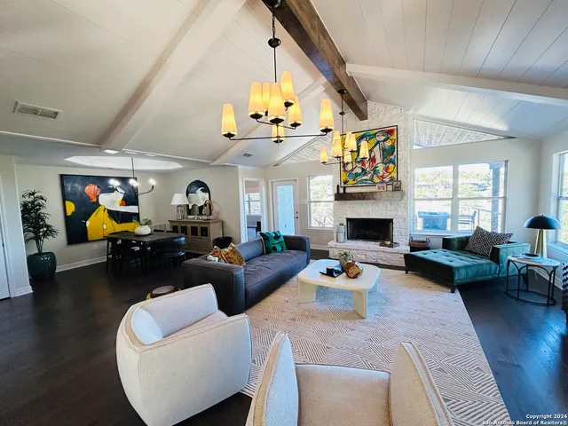 a living room with furniture fireplace and a window