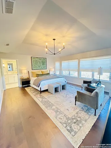 a bedroom with bed couch and window