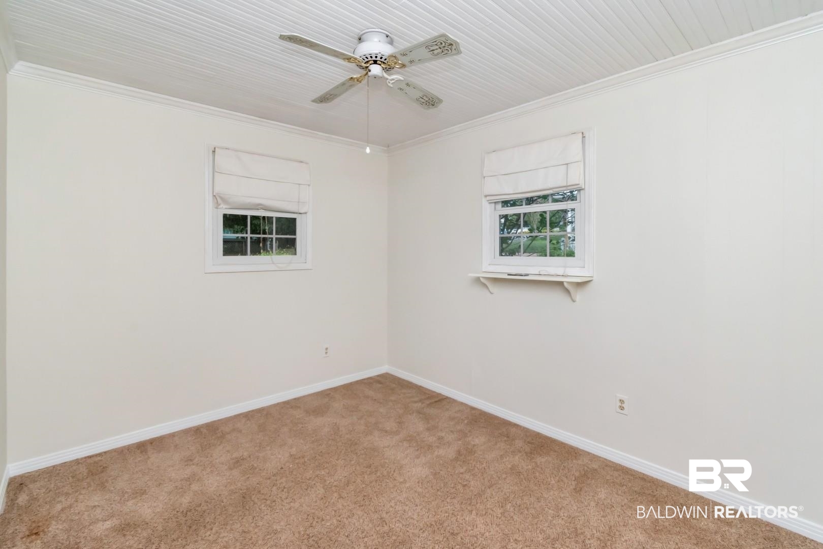 33 Lancaster Road Mobile, AL 36608 - Photo 20 of 40 Spare room featuring carpet, crown molding, a ceiling fan, baseboards, and plenty of natural light