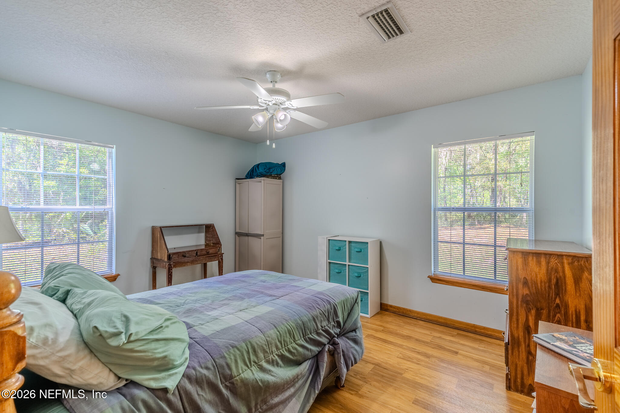 1801 Lake Road Jacksonville, FL 32226 - Photo 27 of 72 a spacious bedroom with a bed a dresser and wooden floor