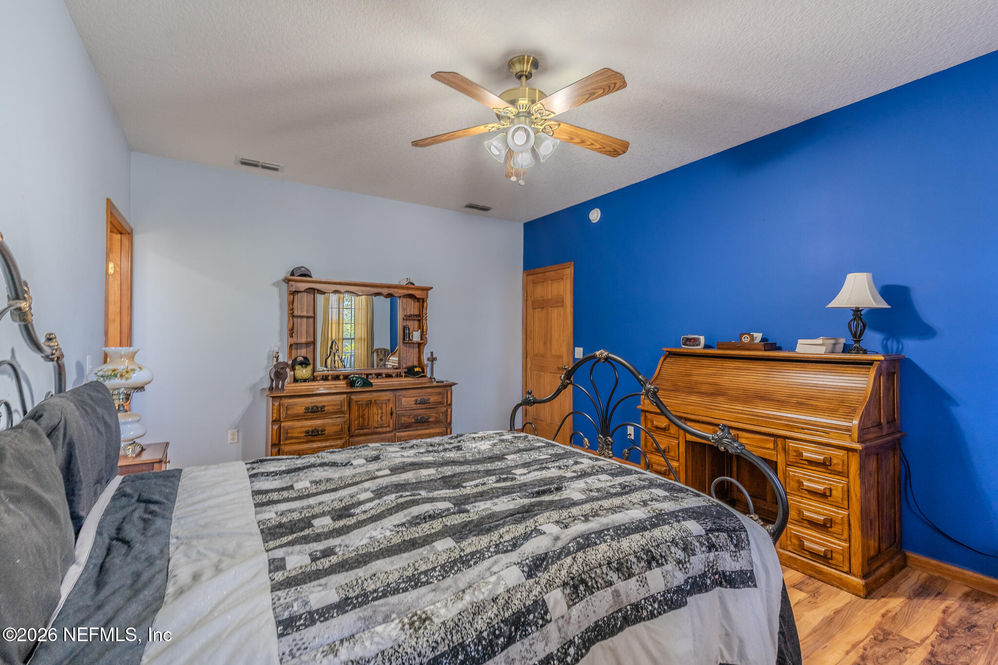 1801 Lake Road Jacksonville, FL 32226 - Photo 45 of 72 a bedroom with a bed and a chandelier