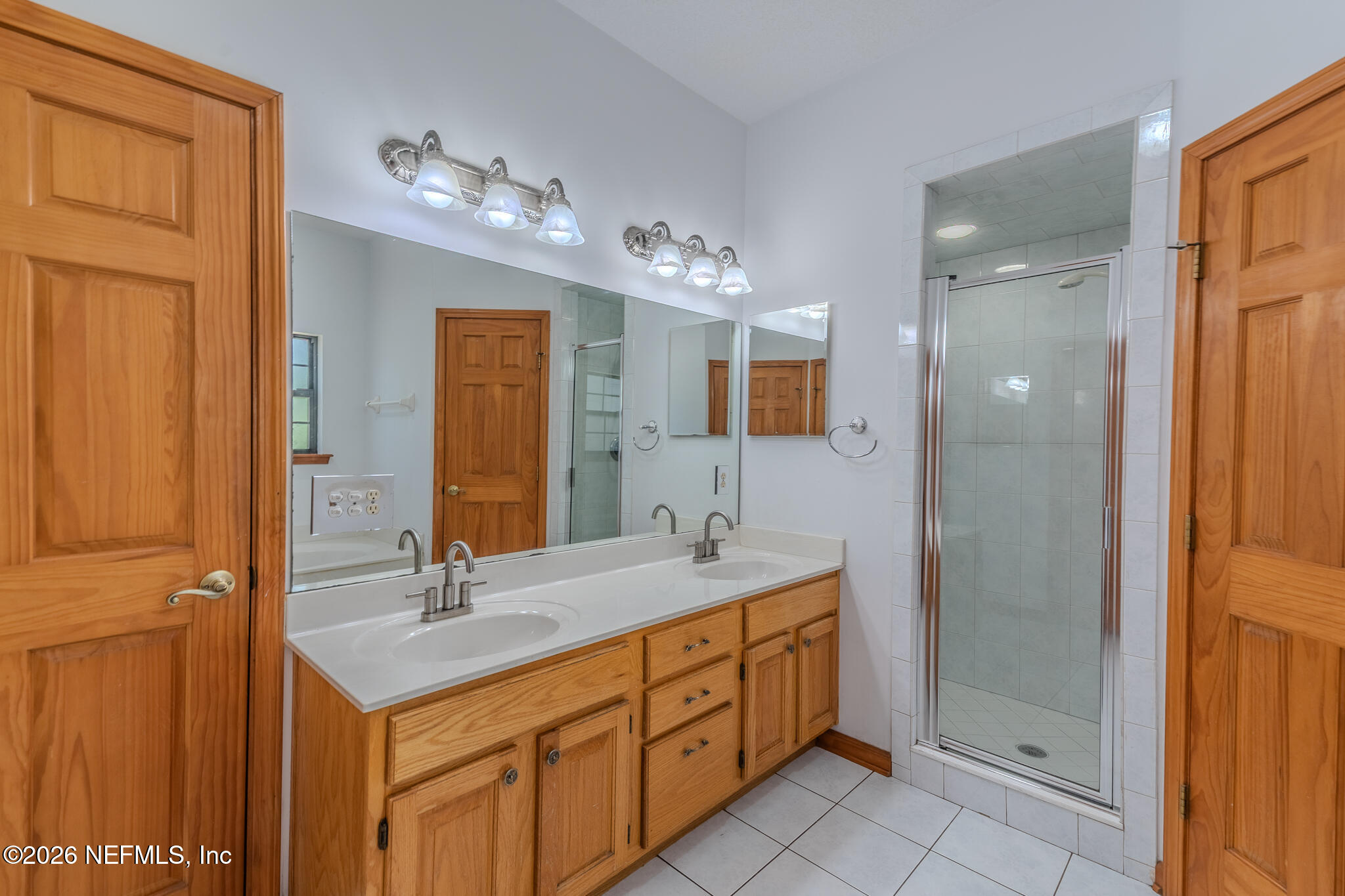 1801 Lake Road Jacksonville, FL 32226 - Photo 49 of 72 a spacious bathroom with a double vanity sink a mirror and a shower