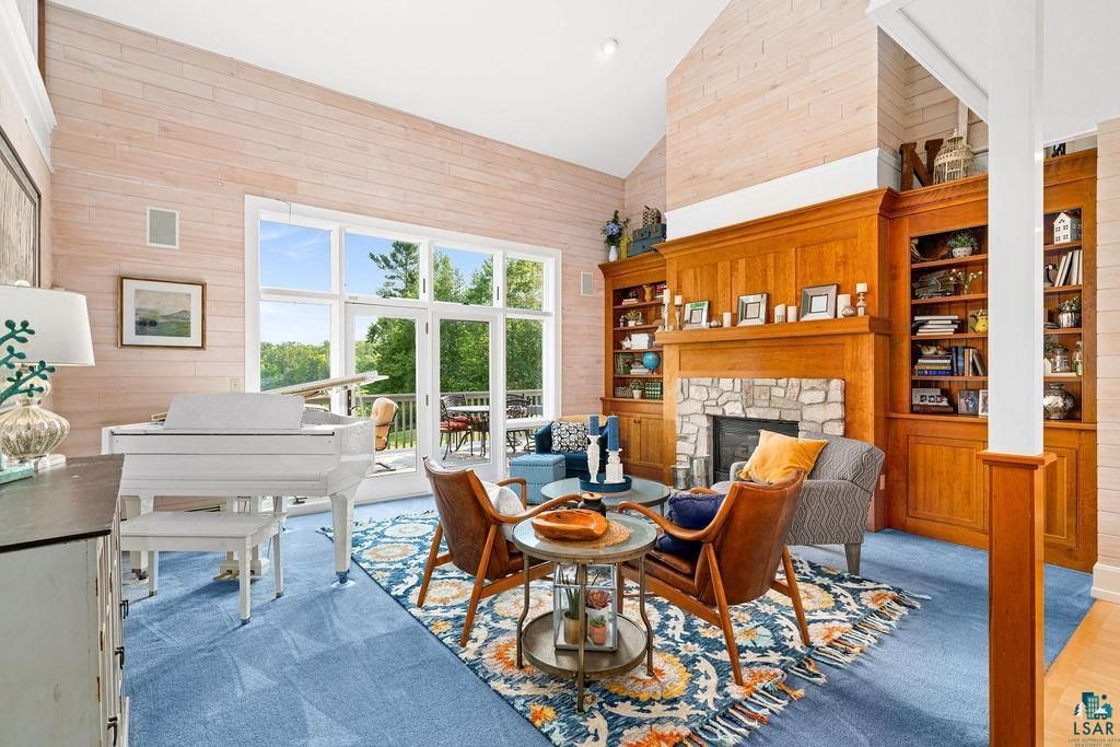 3168 Pioneer Road Barnum, MN 55707 - Photo 5 of 46 This great room features an expansive, vaulted ceiling, with a stone and maple encased fireplace. With beautiful light throughout the day, it's the perfect place to cozy up with a book or play the piano.