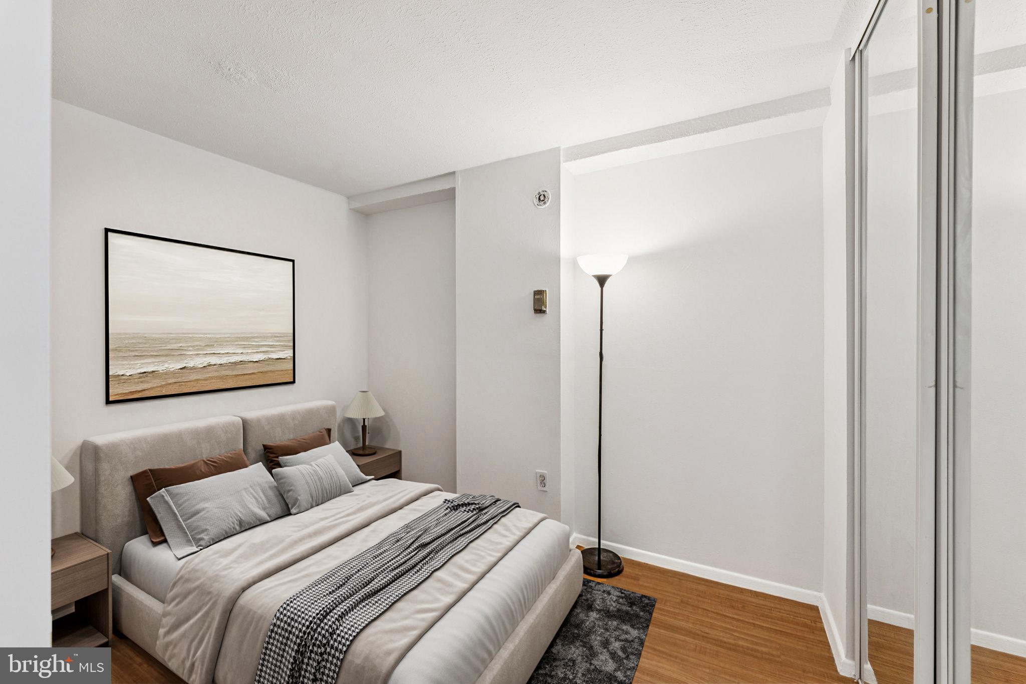 1440 N Street Northwest, Unit 312 Washington, DC 20005 - Photo 14 of 31 a bedroom with a bed and a painting on the wall