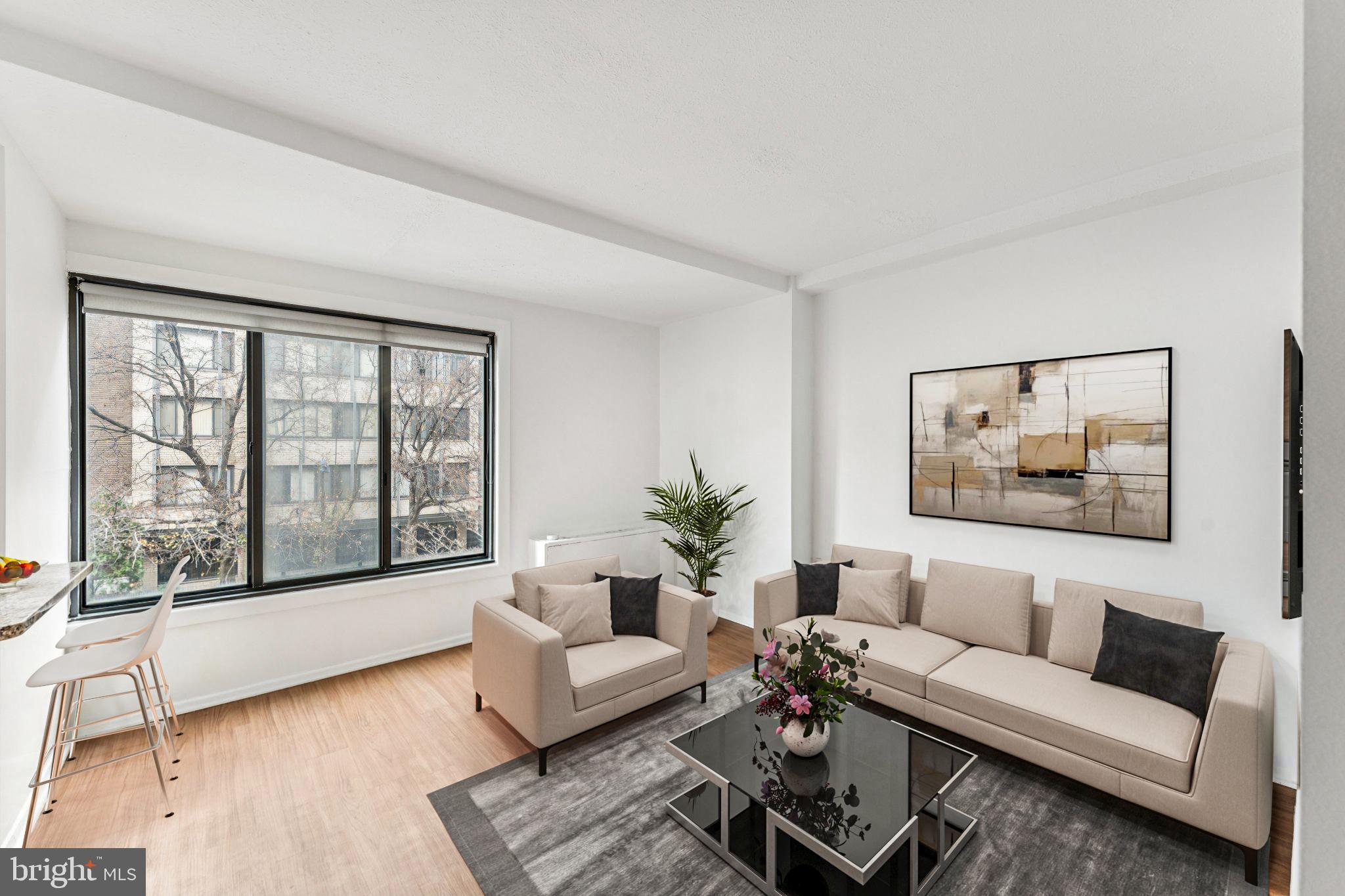 1440 N Street Northwest, Unit 312 Washington, DC 20005 - Photo 3 of 31 a living room with furniture and a large window